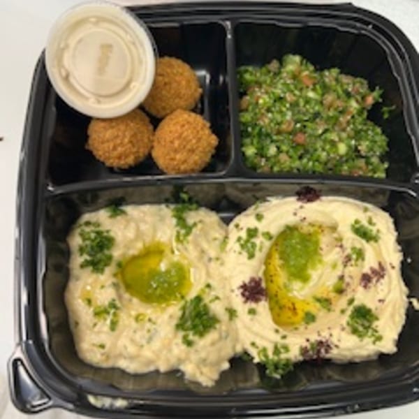 Hala's Grill halal platter with falafel, tabbouleh, baba ghanoush, and hummus with olive oil.